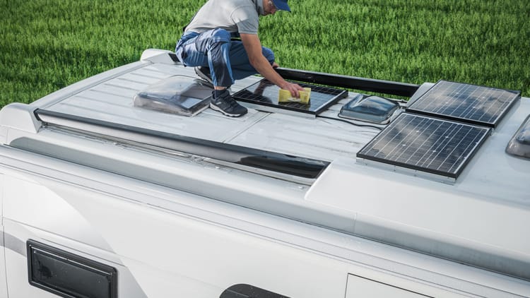 man doing RV solar setup on the roof of his motorhome